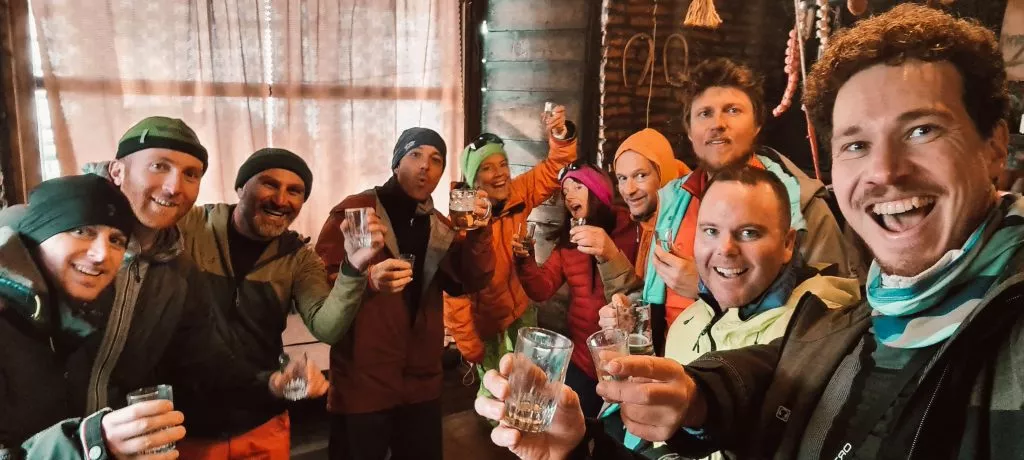 A large group of men and women enjoy Georgian apres-ski in Bar Bakhmaro