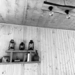 Lounge decoration in Terrace Bakhmaro - bottles and light fittings on wood panel walls