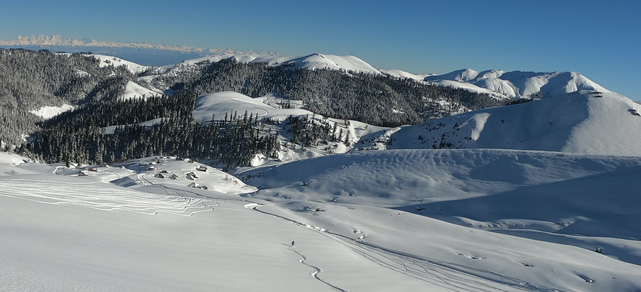 Backcountry skier heads off piste down to Bakhmaro in Georgia
