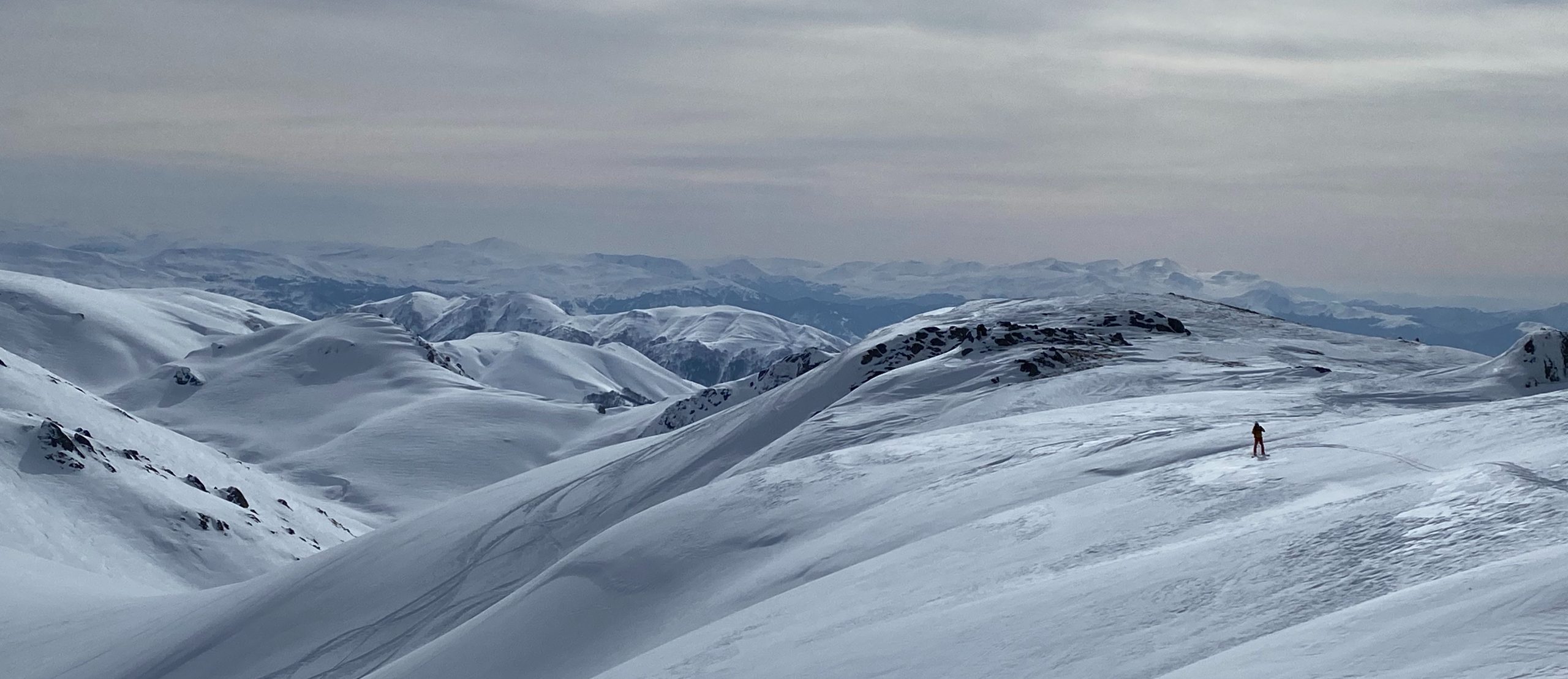 Solo freeride skier in Bakhmaro looking over the Caucasus mountains
